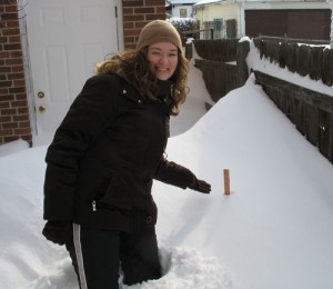 Amy stands next to a yardstick... yes, lots of snow!