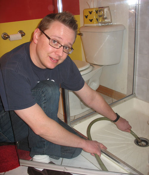 Steve drains the old tank into our 2nd bathroom shower