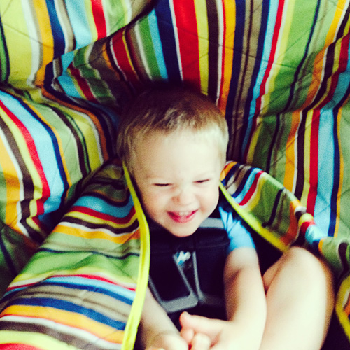 We set up a blanket for Wes in the car to encourage him to sleep. Instead, he started playing with it and turned it into a fun tent!! So much for nap time in the car!